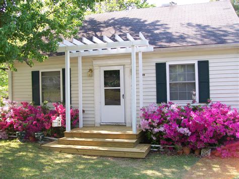 metal pergola on the front of a house|small pergola over front door.